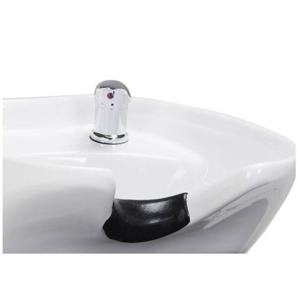 Close-up of a white bathroom sink with a chrome faucet and a chipped edge showing black interior material nearby.